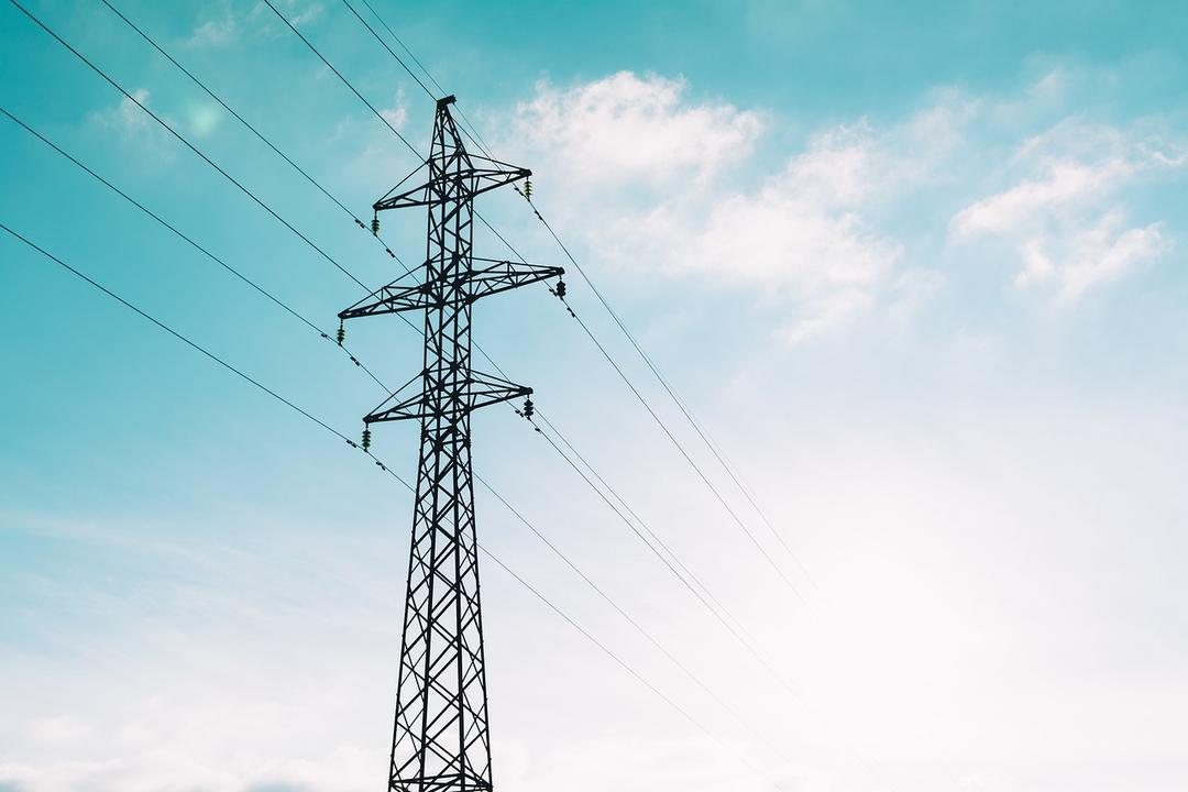 Electrical power lines against a blue sky
